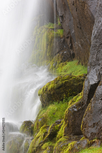 Obraz na płótnie Waterfall and basalt rocks covered by moss. Seydisfjordur. Iceland w salonie