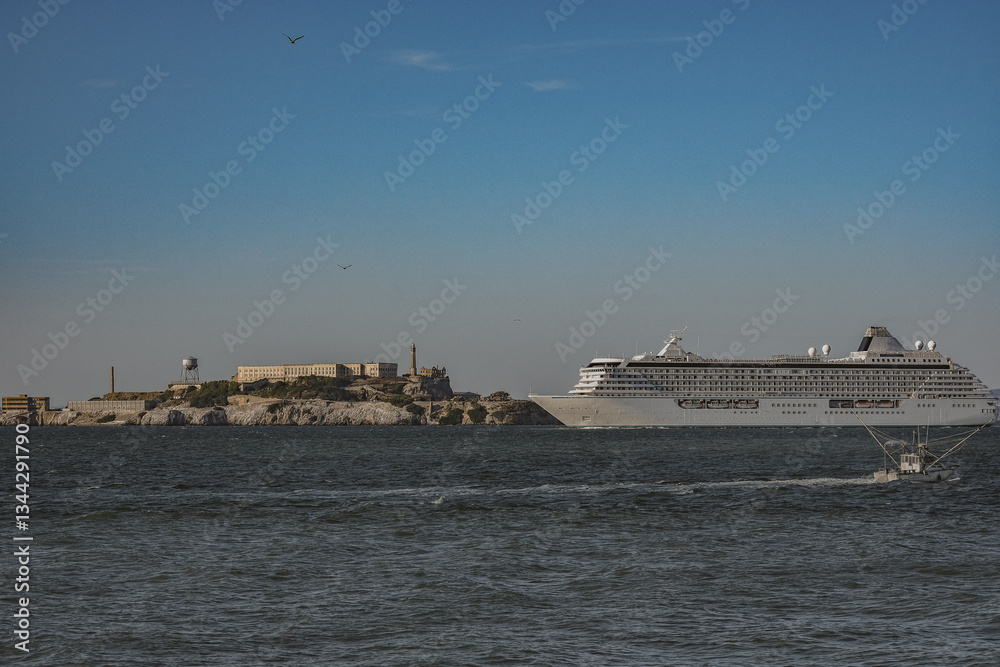 Luxury cruiseship cruise ship liner Serenity sail away departure from San Francisco port through bay towards Golden Gate Bridge on sunny day Luxury cruiseship cruise ship liner Serenity sail away departure from San Francisco port through bay towards Golden Gate Bridge on sunny day