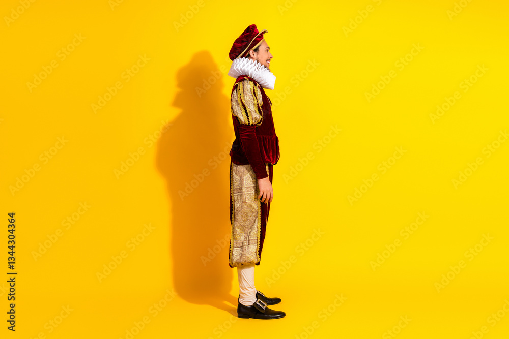 Fototapeta premium Portrait of a man wearing a baroque costume and posing against a vibrant yellow background