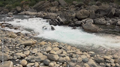 Slow motion video of water flowing through rocky landscape