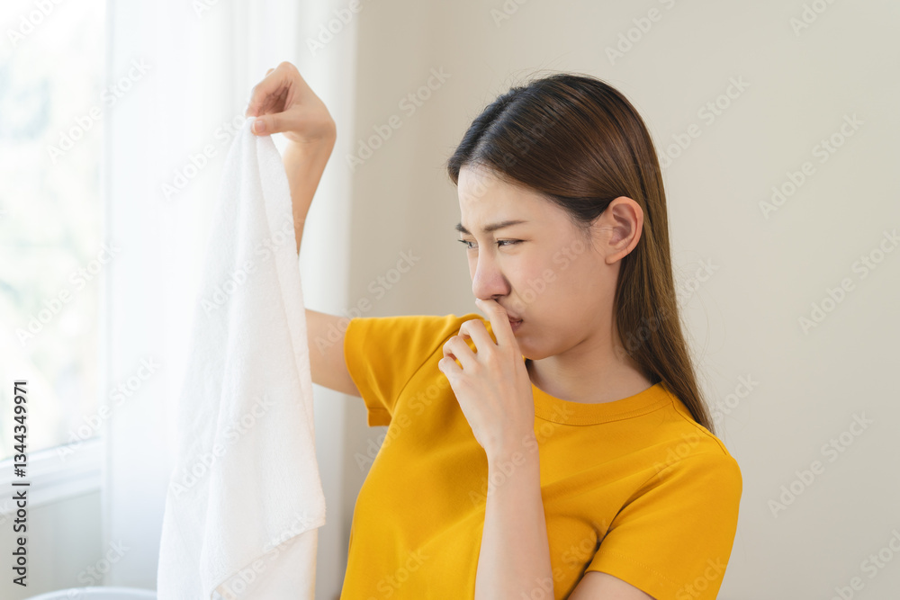 Young people doing laundry smelling for dirty clothes. Young people doing laundry smelling for dirty clothes.