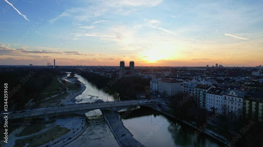 4K aerial drone video of St Maximilian Parish historical landmark of Munich Germany centrally located by the Isar river overlooking the city panorama at sunset on a sunny day
