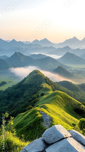 Obraz na płótnie Misty mountain range at sunrise. Lush green hills and valleys w salonie
