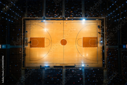 Aerial view of an illuminated basketball court during a game  
