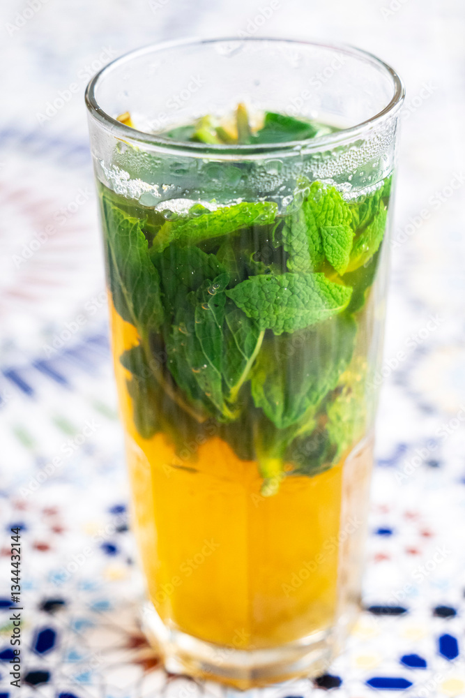 Fototapeta premium glass of typical Moroccan mint tea, Café Hafa, Tangier, Morocco, North Africa