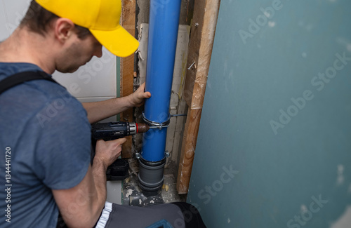 A man installing a new sewer drain stack.