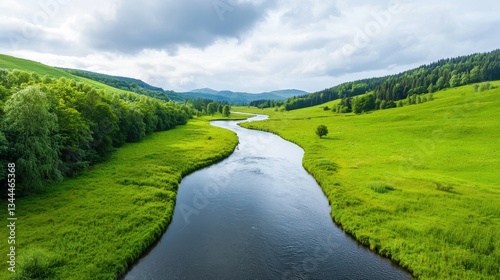 Serene River Flowing Through Lush Green Landscape Under Cloudy Sky