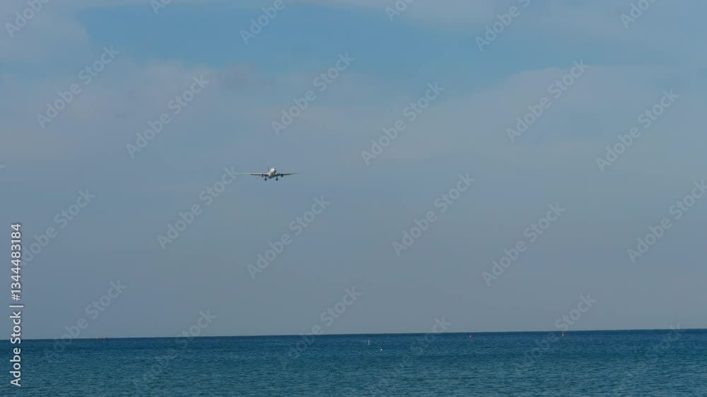 Airplane with an unrecognizable livery approaching landing, front view, long shot Airplane with an unrecognizable livery approaching landing, front view, long shot