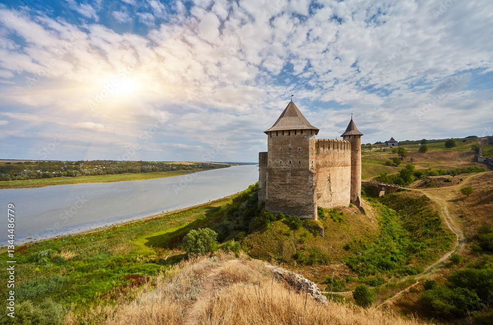 Ancient fortress in Khotyn in morning sun with mist, West Ukraine. Fortification on the banks of the Dniester River, one of the most famous and largest castles in Ukraine. Ancient fortress in Khotyn in morning sun with mist, West Ukraine. Fortification on the banks of the Dniester River, one of the most famous and largest castles in Ukraine.