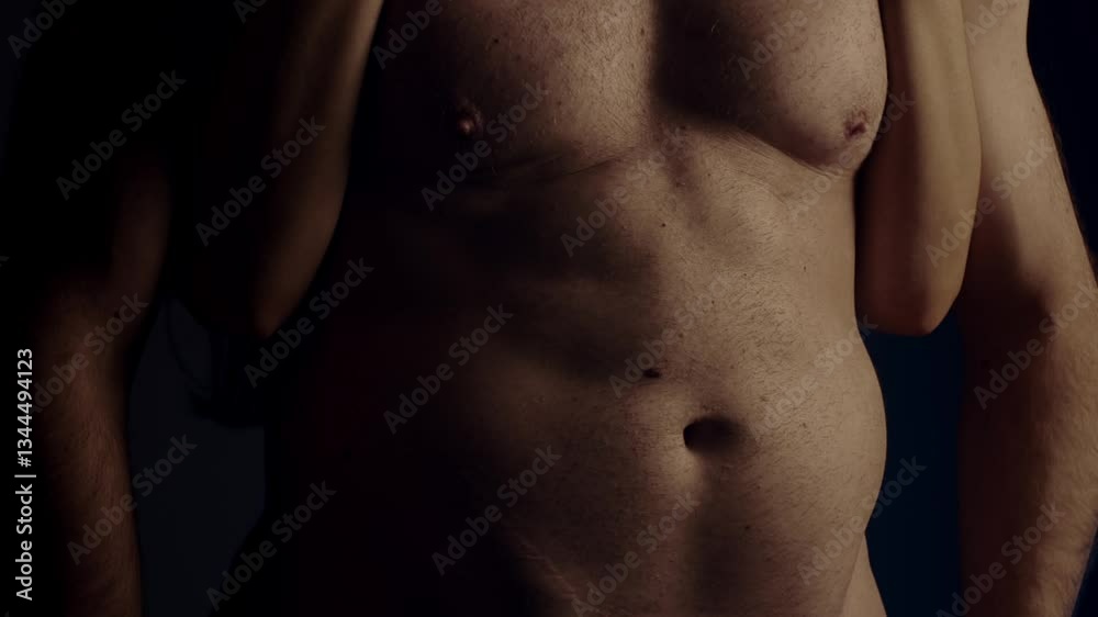 Female hand touching male muscular torso. Slow motion Female hand touching male muscular torso. Slow motion