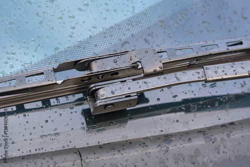 Obraz na płótnie Offset hook wiper arm close-up, wiper blade on wet windshield during rain. Wiper blade with offset adapter for for effective rain and dirt removal, clear visibility and safe driving in rainy weather w salonie