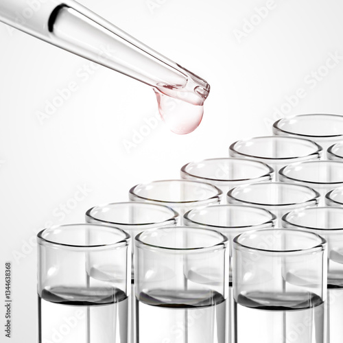 Liquid drop from laboratory glass pipette to test tube
