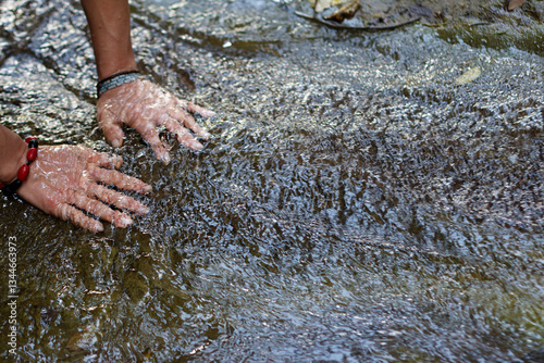 Obraz na płótnie Female Hands submerged in flowing stream of water in Villeta, Cundinamarca, Colombia. Close-up interaction with nature highlighting sensory experience w salonie