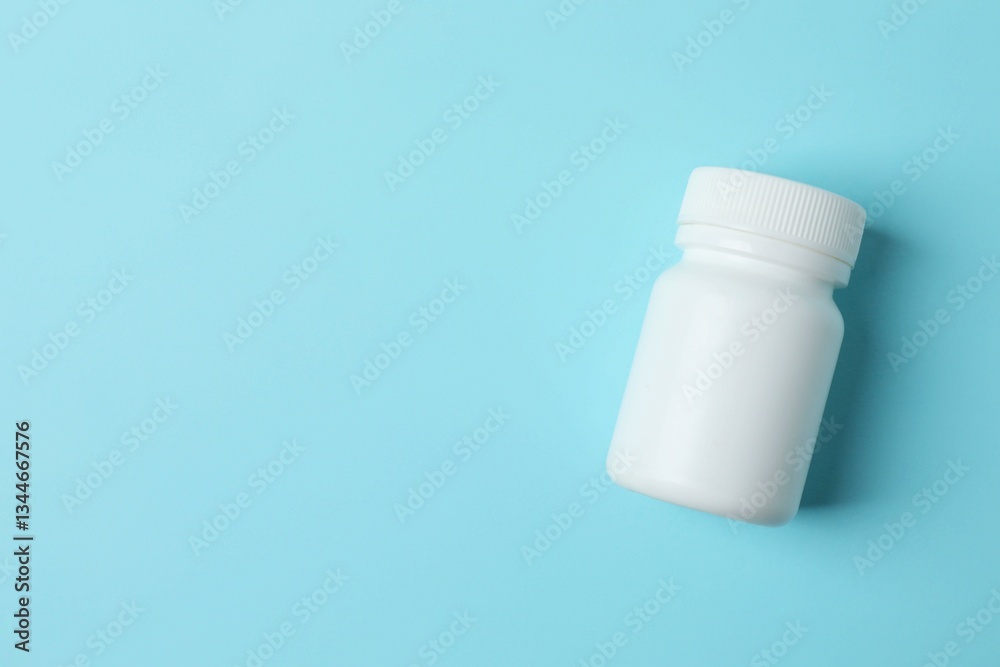 White bottle on blue background, top view White bottle on blue background, top view