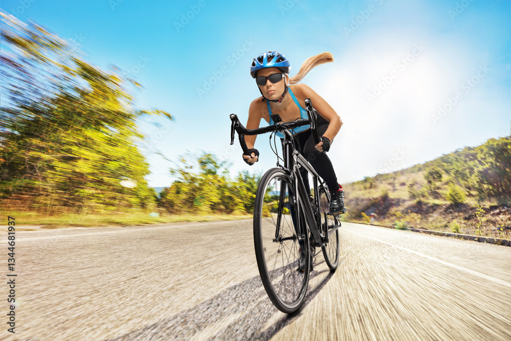 Naklejka premium Female cyclist riding a bicycle fast