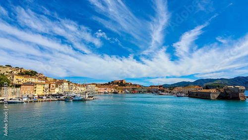 Panoramic view from the Mediterranean sea to the ancient Italian town Portoferraio and yachts on Elba Island in sunny day.
