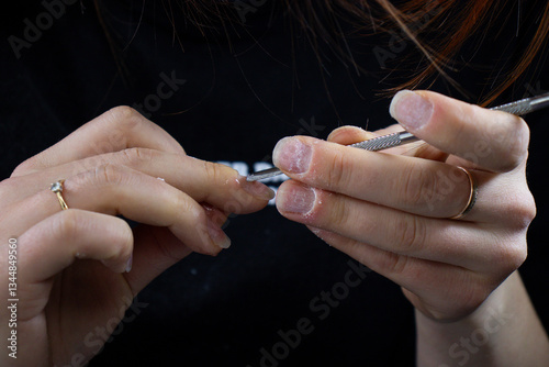 Nail Technician Using Electric Nail Drill for Manicure and Nail Care