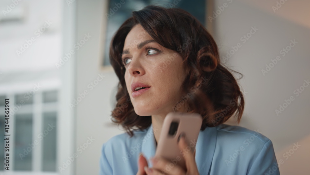 Worried entrepreneur finish call thinking on work problem at office closeup Worried entrepreneur finish call thinking on work problem at office closeup