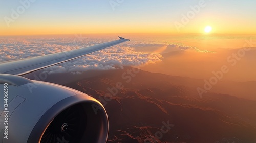 A clear sky and mountains viewed from the window of a commercial airplane during the day, with crisp details and soft sunlight.