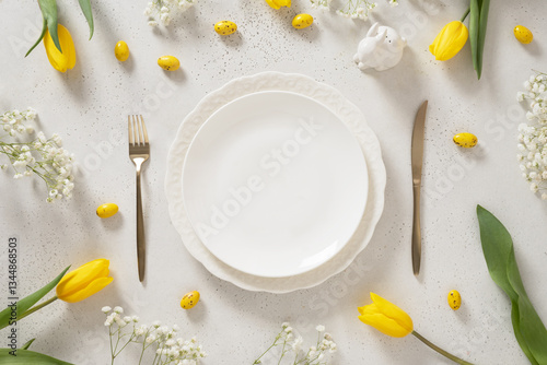 Obraz na płótnie Easter table setting with spring, yellow tulips, empty white plates, bunny, eggs on white background. Happy Easter celebration. Copy space. View from above. w salonie