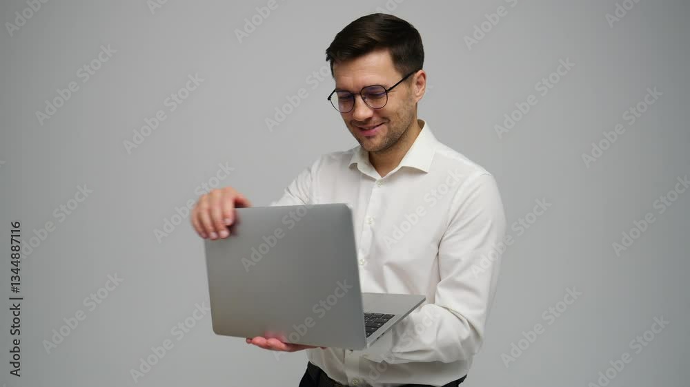 Young professional with laptop smiles confidently in studio setting during a business presentation Young professional with laptop smiles confidently in studio setting during a business presentation