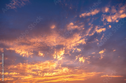 Fototapeta Naklejka Na Ścianę i Meble -  Sky clouds sunset background. Stunning view of golden, lilac and pink clouds and blue sky