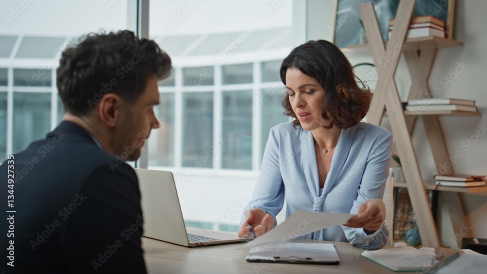 Two partners discussing contract at office closeup. Woman explaining agreement Two partners discussing contract at office closeup. Woman explaining agreement