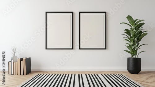 A minimalist interior featuring two empty frames  a potted plant  and a striped rug  creating a clean and modern aesthetic.