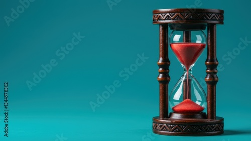 Obraz na płótnie Hourglass with red sand and wooden frame sits against aquamarine background Represents time management, vintage decor, and life lessons w salonie