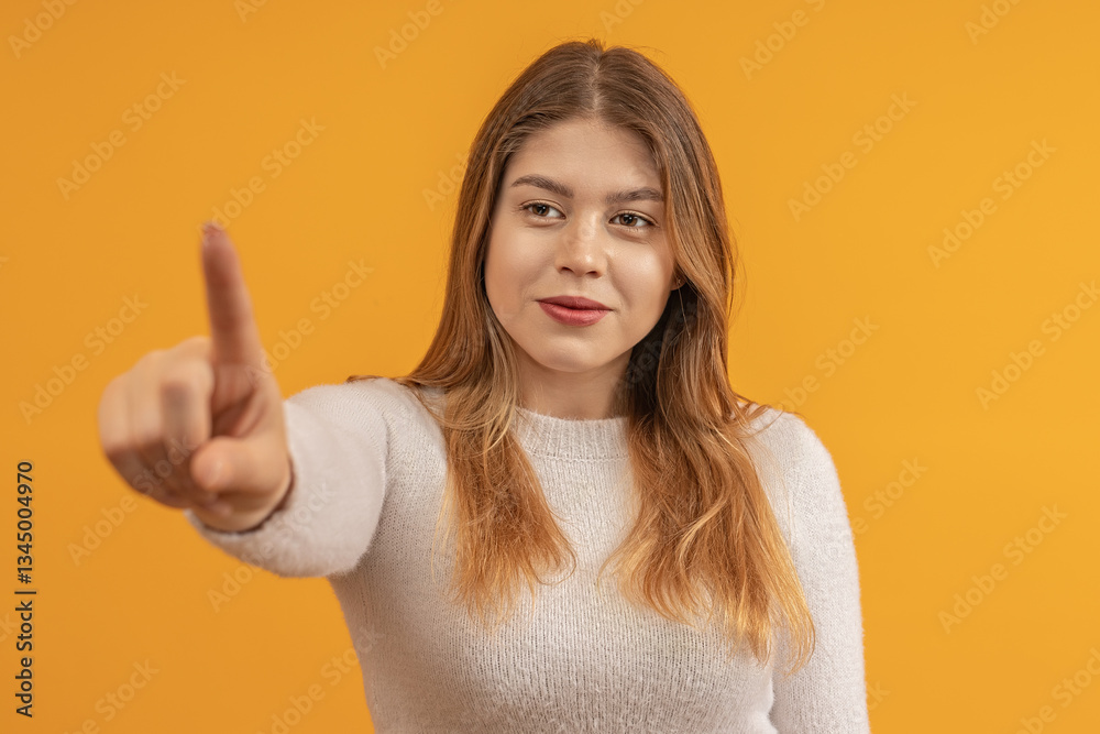 Smiling young woman pointing at camera with a confident look Smiling young woman pointing at camera with a confident look