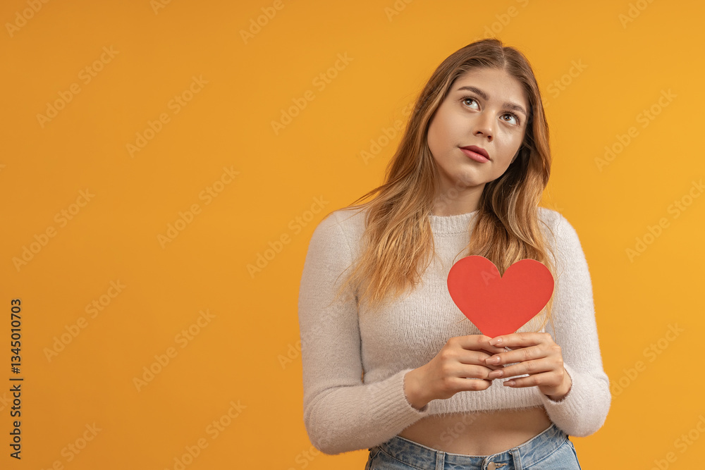 Woman with heart card looking skeptical Woman with heart card looking skeptical