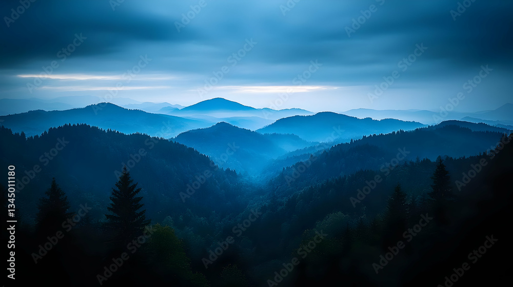 Obraz premium Blue Mountain Range With Dense Forest And Cloudy Sky Displaying Dramatic Scenery