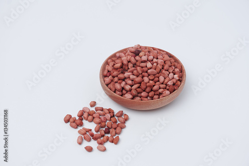 peanuts in wooden bowl, isolated white background