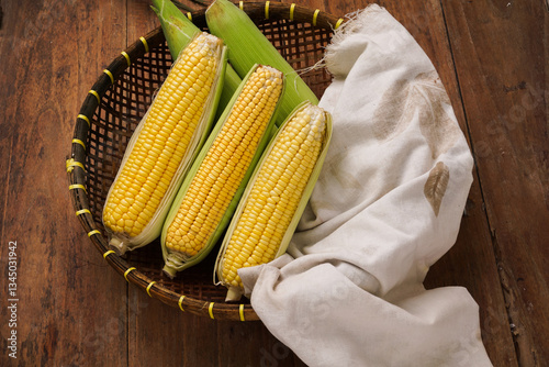 yellow sweet corn on wooden background