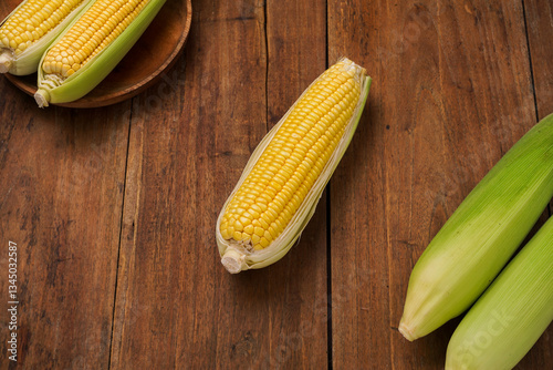 yellow sweet corn on wooden background