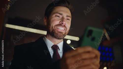 Evening businessman messaging smartphone at city darkness closeup. Man answering