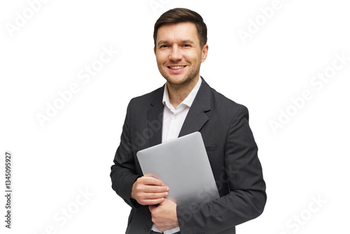 Professional man in a suit holding a laptop while smiling confidently in a studio setting photo