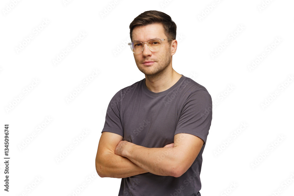 Young man stands confidently with arms crossed in casual attire in a studio setting, showcasing a relaxed demeanor Young man stands confidently with arms crossed in casual attire in a studio setting, showcasing a relaxed demeanor