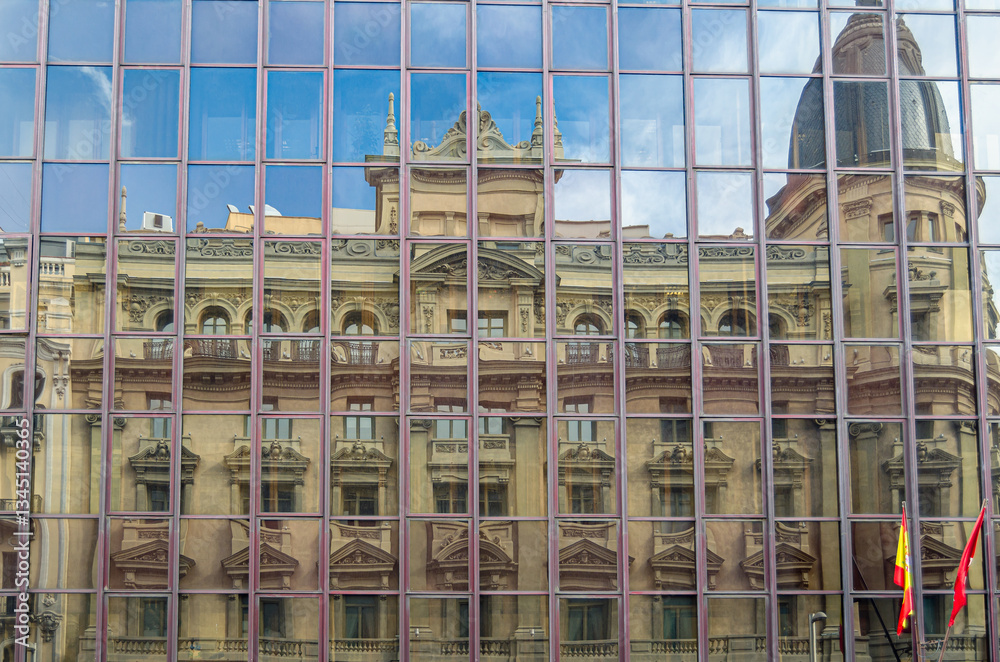 Obraz premium Reflection of buildings on Gran Via in Madrid, Spain