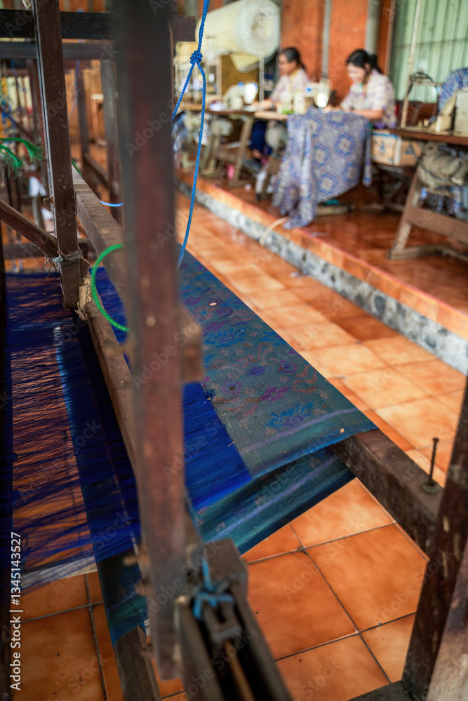 Traditional Hand Weaving in a Textile Workshop with Patterned Fabric and Loom