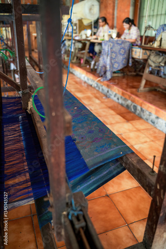 Obraz na płótnie Traditional Hand Weaving in a Textile Workshop with Patterned Fabric and Loom w salonie