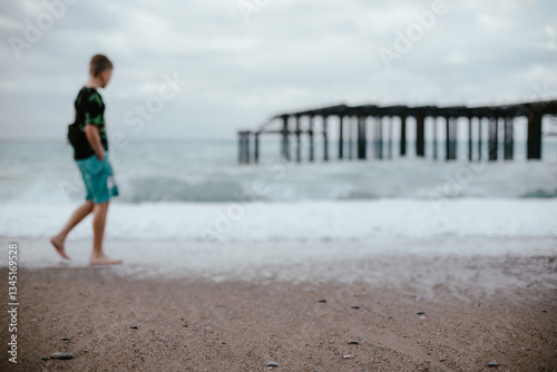 Fototapeta Naklejka Na Ścianę i Meble -  People Walking on a Rocky Beach in Turkey – Autumn Vacation