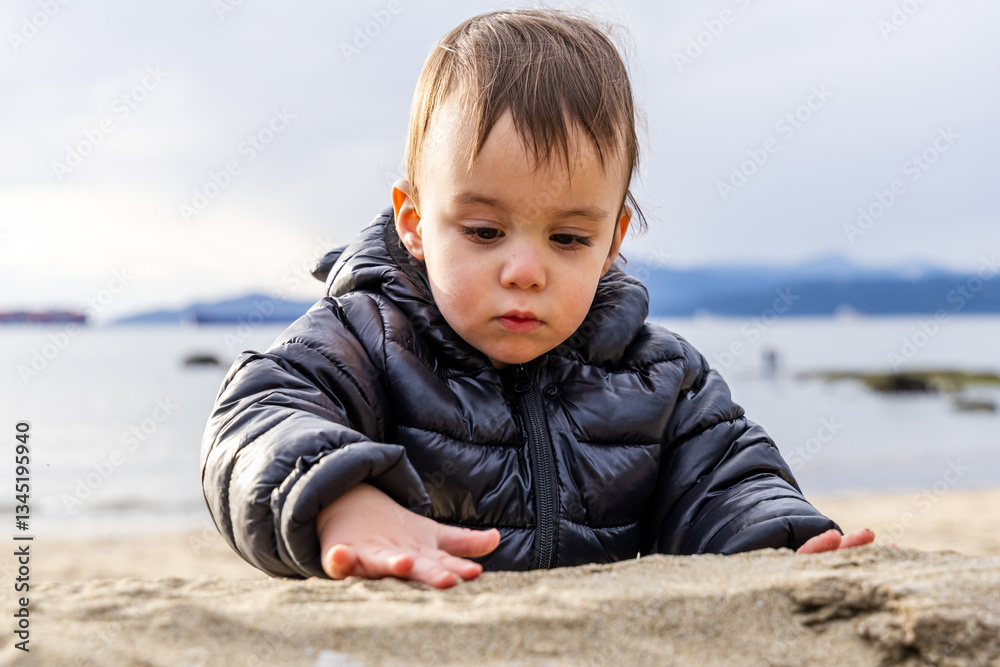Child Exploring Sand on Beach at Stanley Park, Vancouver, Canada Child Exploring Sand on Beach at Stanley Park, Vancouver, Canada