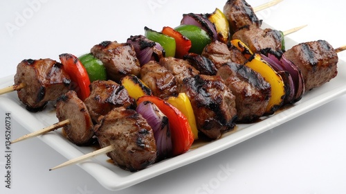 A platter of freshly grilled kebabs with lamb, chicken, and vegetables.