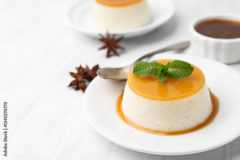 Tasty pudding with caramel sauce served on white tiled table, closeup. Space for text Tasty pudding with caramel sauce served on white tiled table, closeup. Space for text