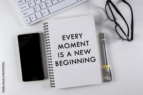 Obraz na płótnie “Every moment is a new beginning†text on notebook with white background. w salonie