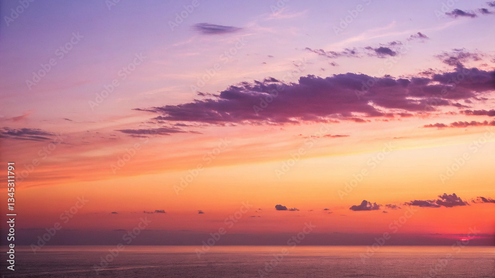 Fototapeta premium Serene sunset over the ocean, painting the sky with vibrant hues of orange, pink, and purple, a breathtaking spectacle of nature's artistry.