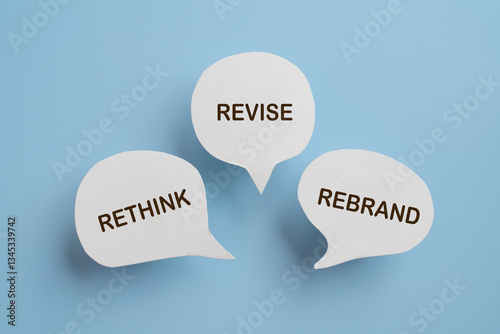 For business management branding concept of rethink revise and rebrand text on real paper cut speech bubble photo