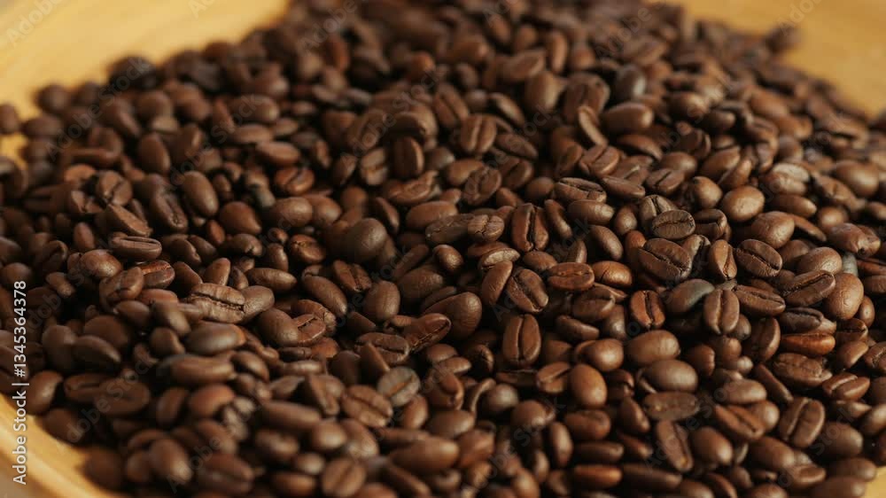 Bowl of coffee beans with a lot of them. The beans are brown and have a lot of them Bowl of coffee beans with a lot of them. The beans are brown and have a lot of them