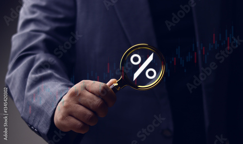 Financial market volatility, interest rates, economic trends, financial interest rate concept and market trends, businessman holding magnifying glass with percentage symbol.